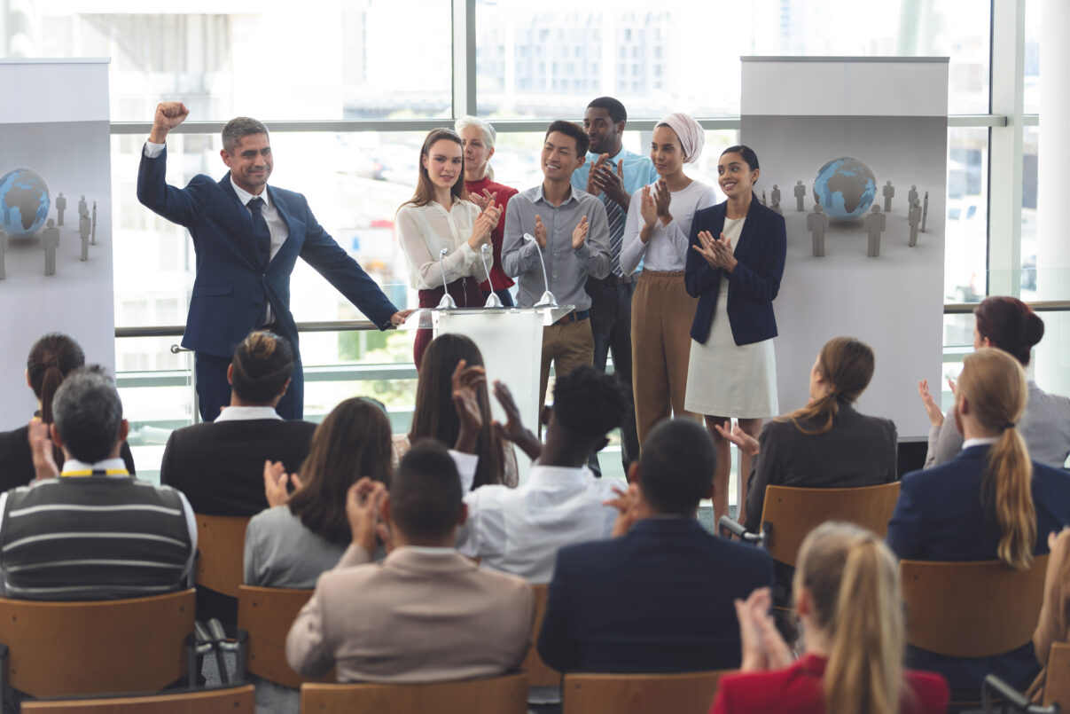 Actividades de gamificación en eventos de formación - businessman standing on podium with diverse collea 2025 04 04 03 29 36 utc