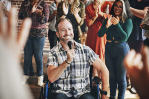 Blog 218 Blog - handicapped man speaking on a microphone in a work 2026 03 19 03 54 36 utc