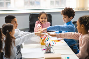 Blog 226 Blog - happy multiethnic schoolchildren putting hands tog 2026 01 08 23 23 23 utc